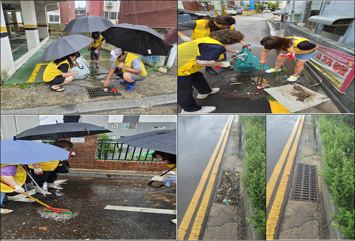 Members of the Guwol 1-dong Neighborhood Watch Council remove sediment from inside a storm drain.