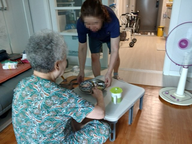 A resident receiving housework support, such as cleaning, through Namdong-gu's integrated care service